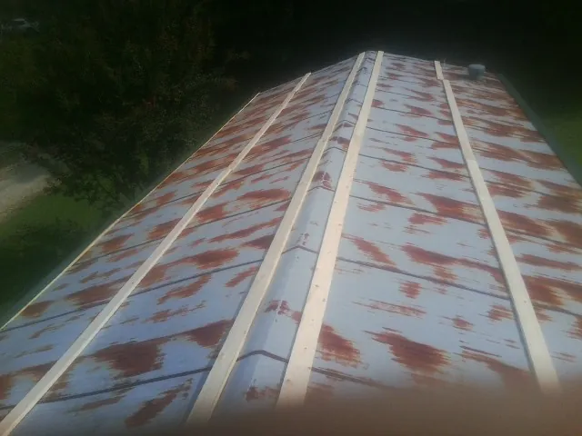 Rusted metal roof panels with new wood purlins before replacement — Storm Damage Roof Repair in Charles Town by Roofing Brothers